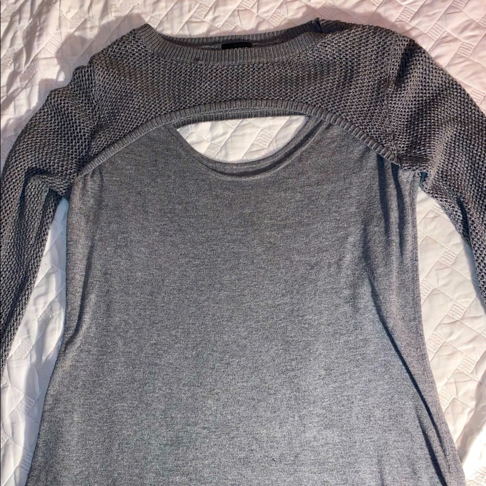 gray long sleeved shirt with fishnet type fabric on the sleeves
